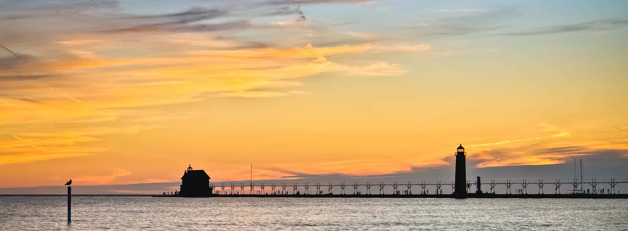 Grand Haven, Michigan pier and lighthouses on Lake Michigan at sunset