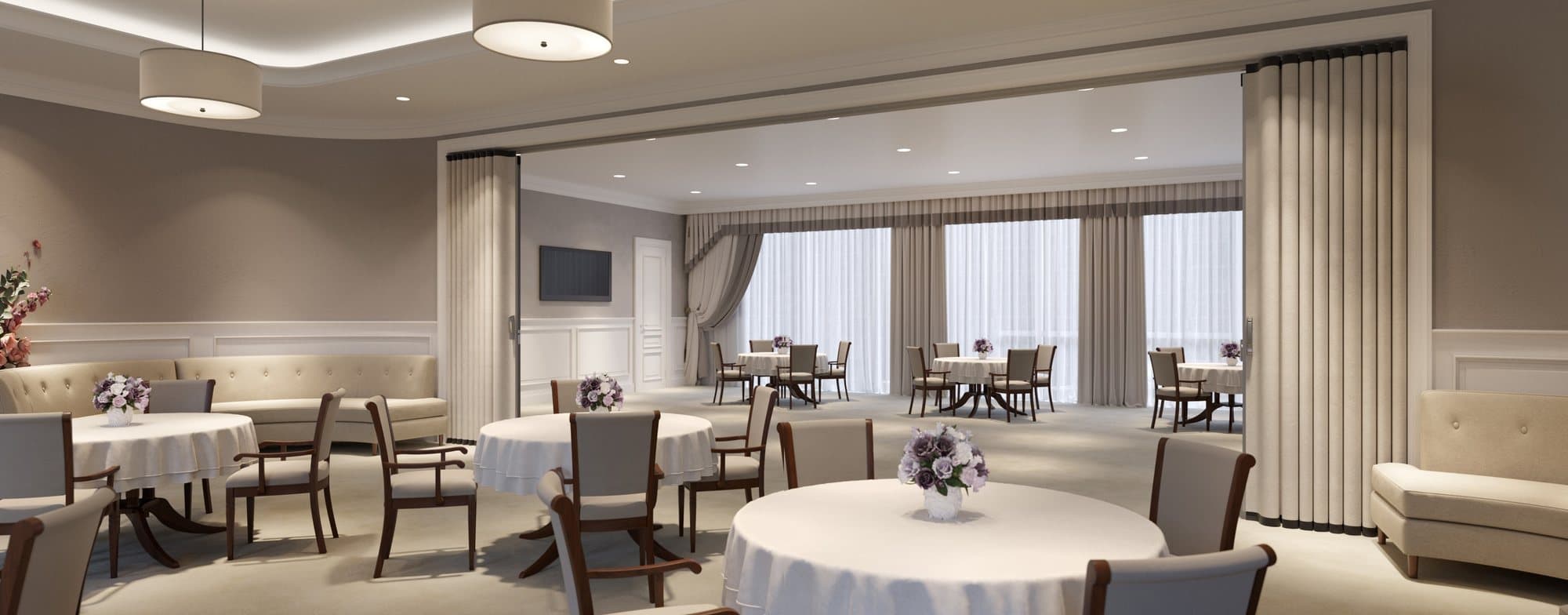 Pair of beige accordion partitions stacked open at each side of a wide opening between two dining rooms with round tables