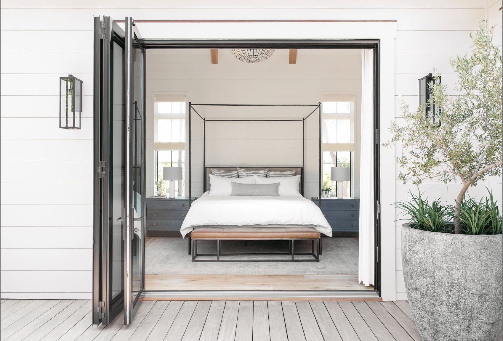 Euro-Wall Vista Fold folding glass doors open from a bedroom to an outdoor deck