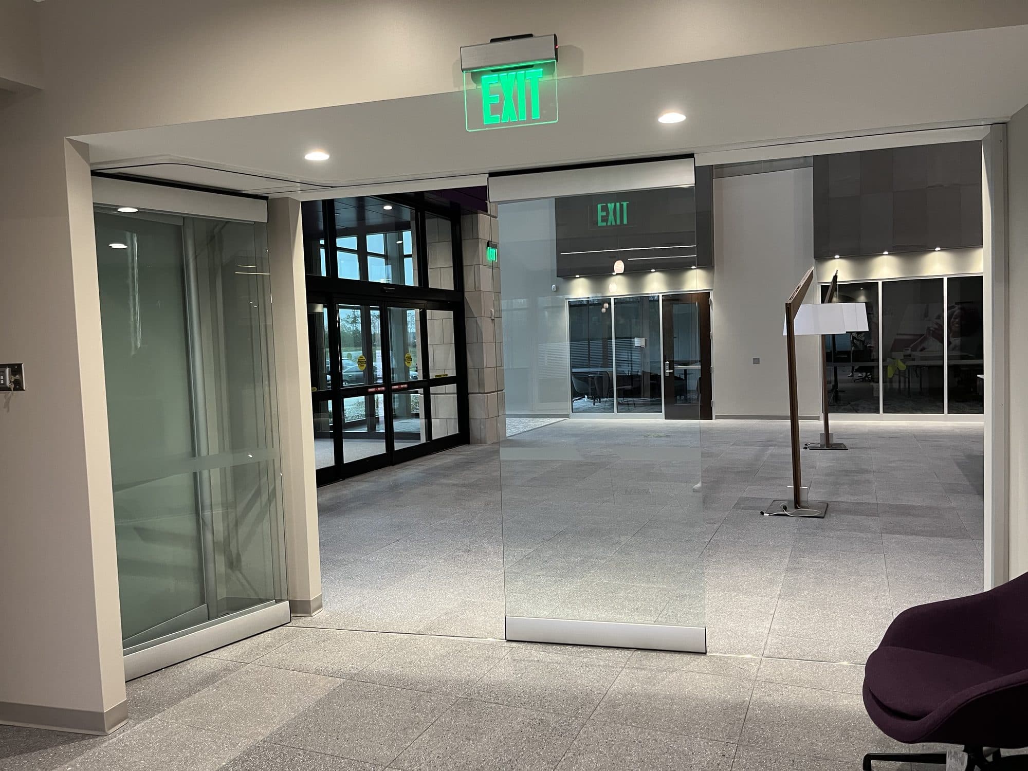 A single PureView glass panel traveling toward the stack on a Modernfold ComfortDrive track, Advia Credit Union, Kalamazoo