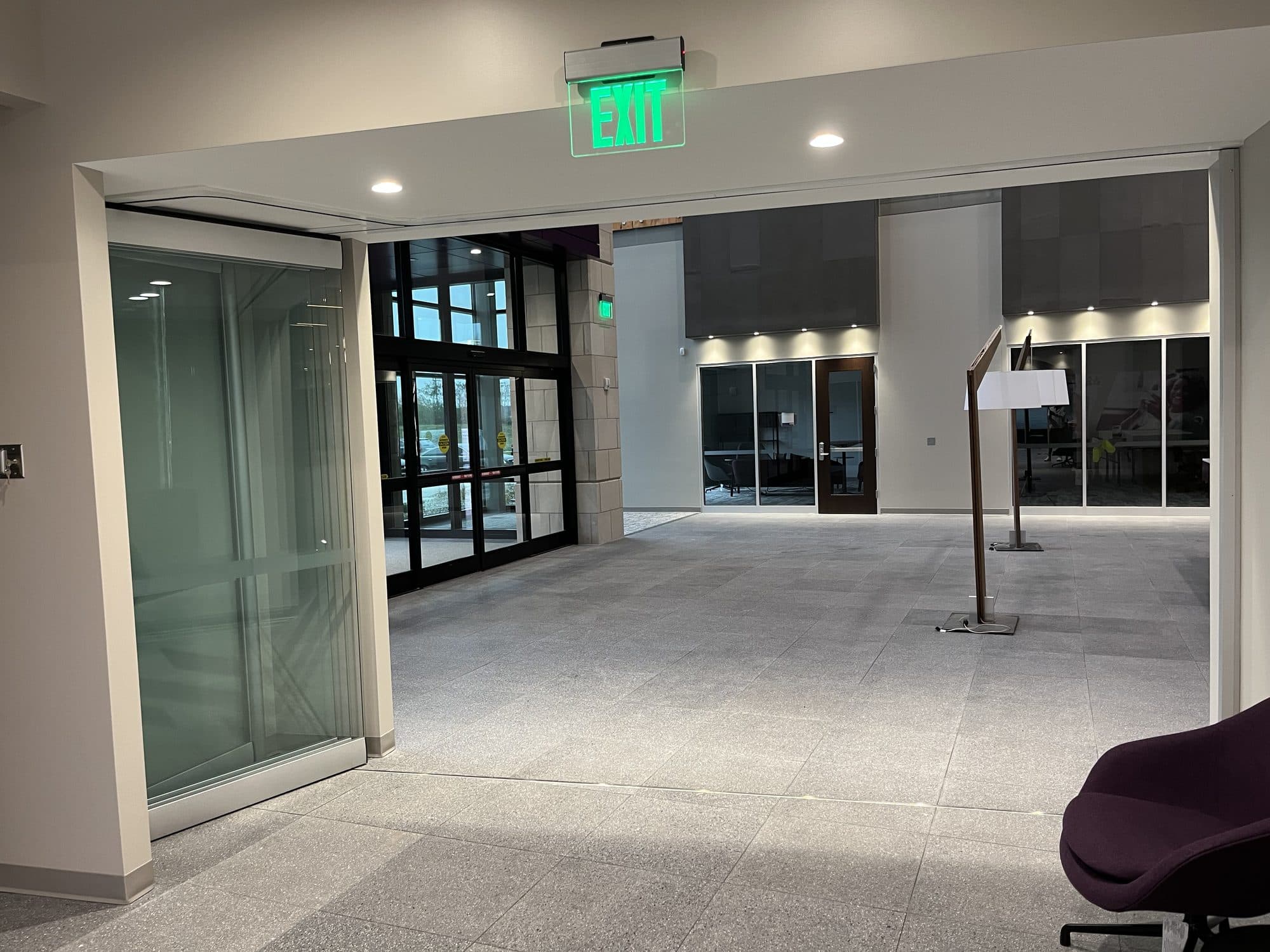 Modernfold ComfortDrive on PureView glass wall stacked open at the side, leaving the room open to the lobby, Advia Credit Union, Kalamazoo