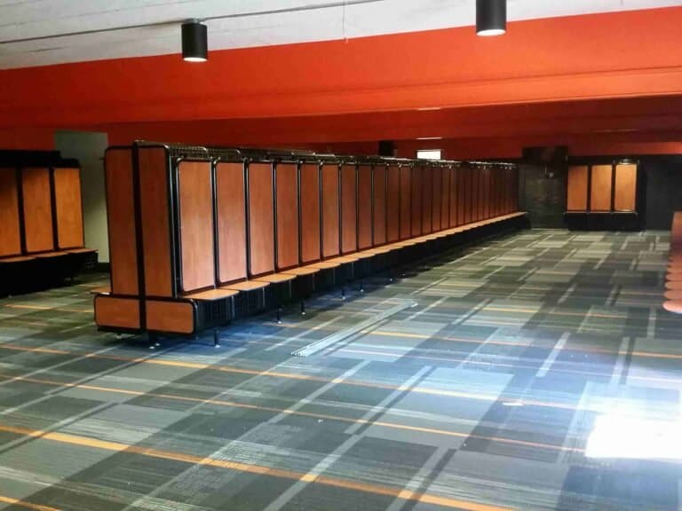 Long run of GearGrid team lockers with wood laminate doors and seats