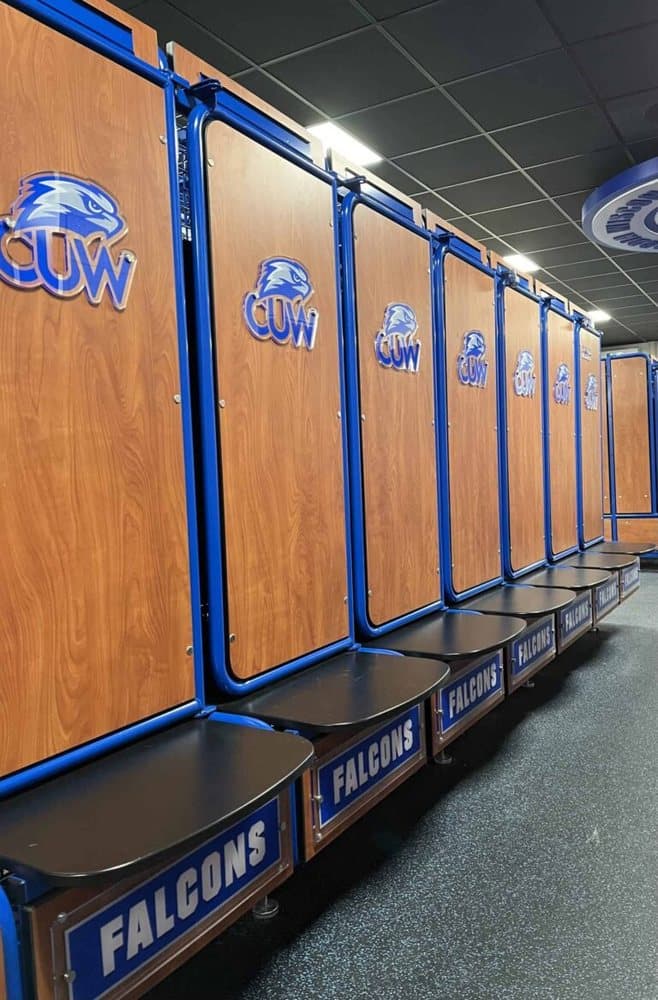 GearGrid GridIron team lockers with wood laminate doors, blue frames and team logos on the seats