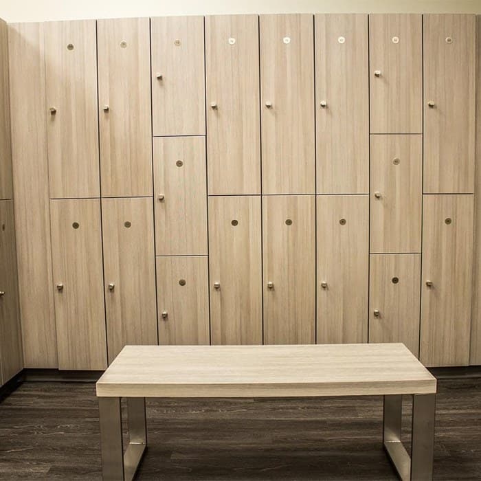 Woodgrain laminate Z-tier lockers with a locker room bench