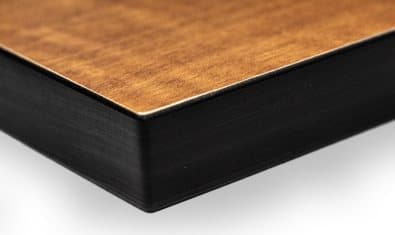 Woodgrain surface and dark core edge of a solid phenolic locker panel