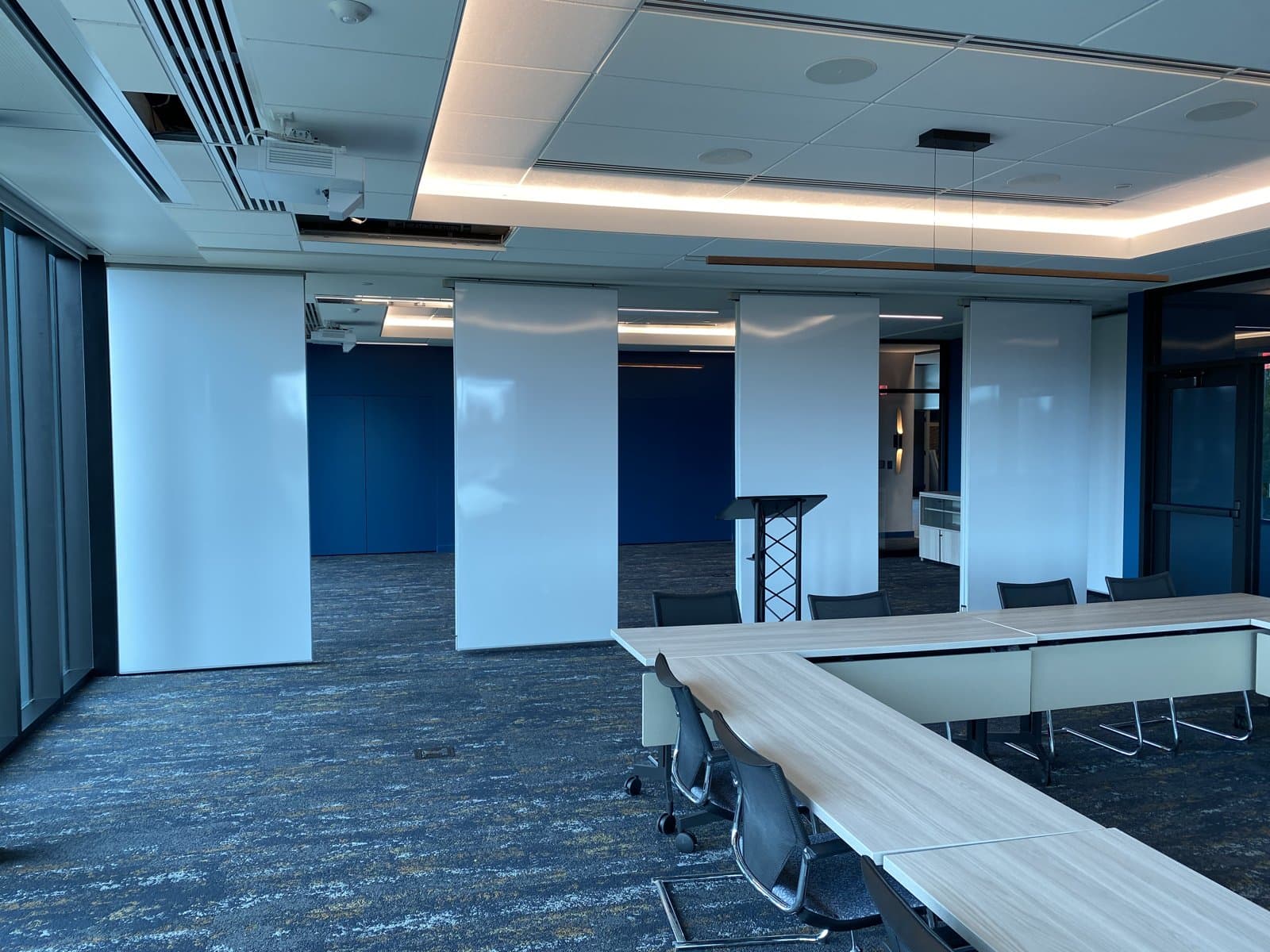 Modernfold trimless markerboard folding panels separating in the Michigan Realtors headquarters boardroom in Lansing, revealing the adjoining meeting room