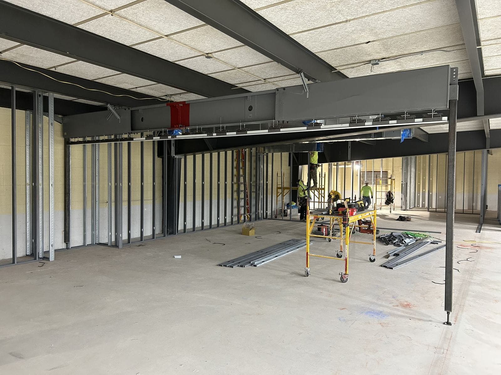 Modernfold Truss System spanning an open room on steel posts at each end, with the track installed along its underside