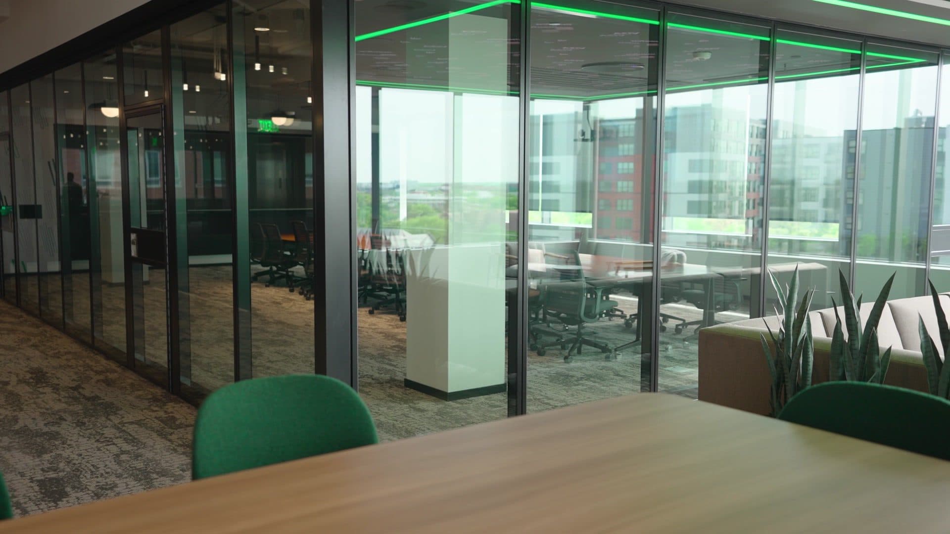 View from inside the boardroom through the closed ComfortDrive glass partition to the open floor and windows