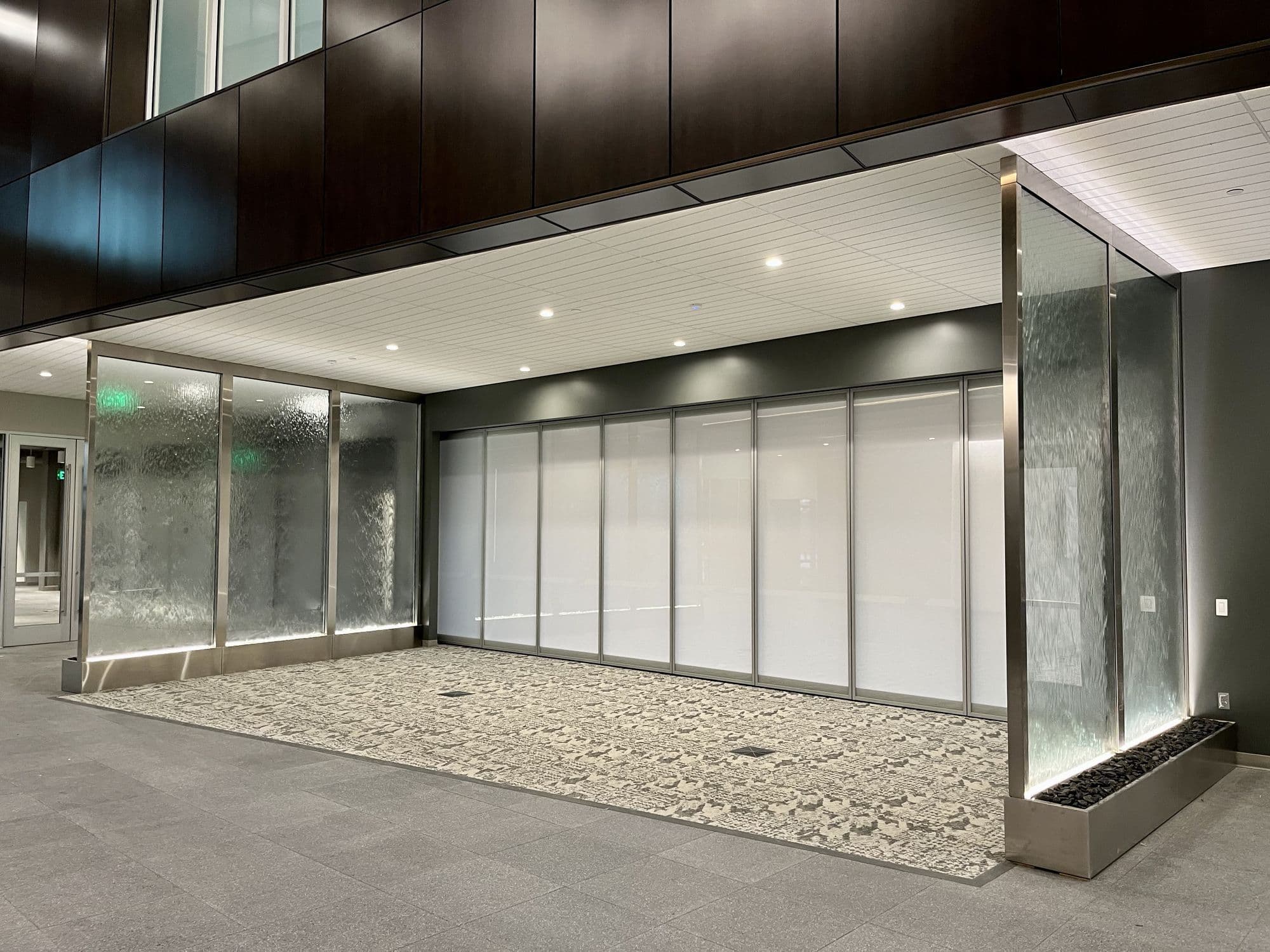 Advia Credit Union lobby with the closed Acousti-Clear wall showing white MorphGlas panels, seen from an angle