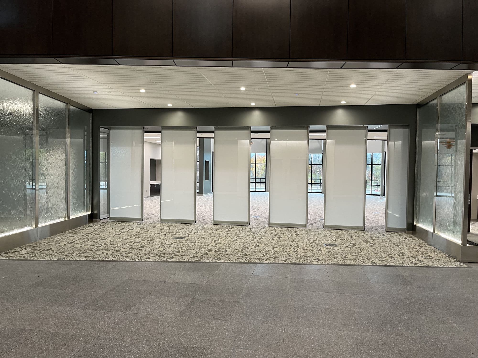 Straight-on view of Acousti-Clear panels spaced across the opening at Advia Credit Union
