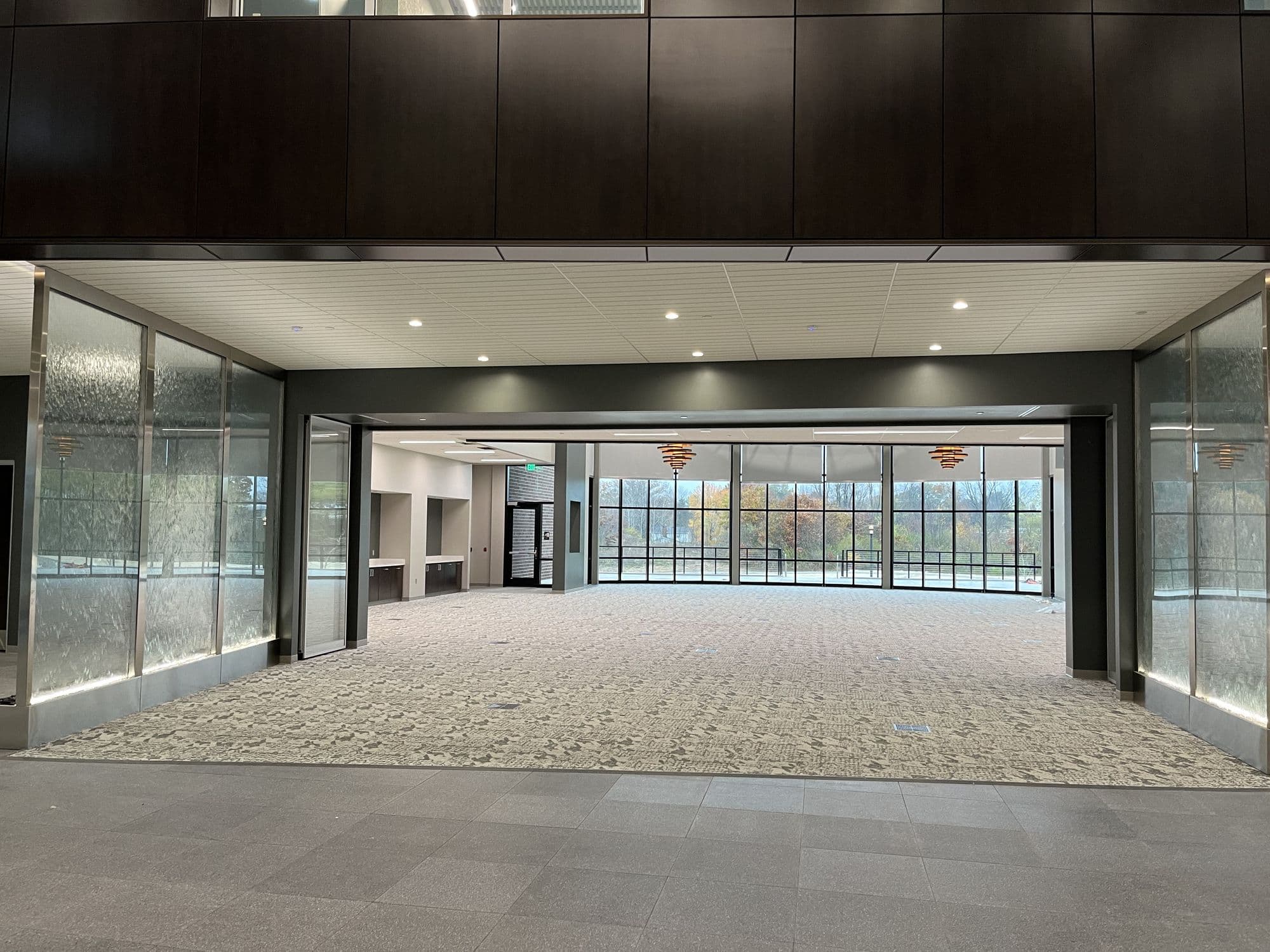 Straight-on view of the fully open room at Advia Credit Union with the glass wall stacked away