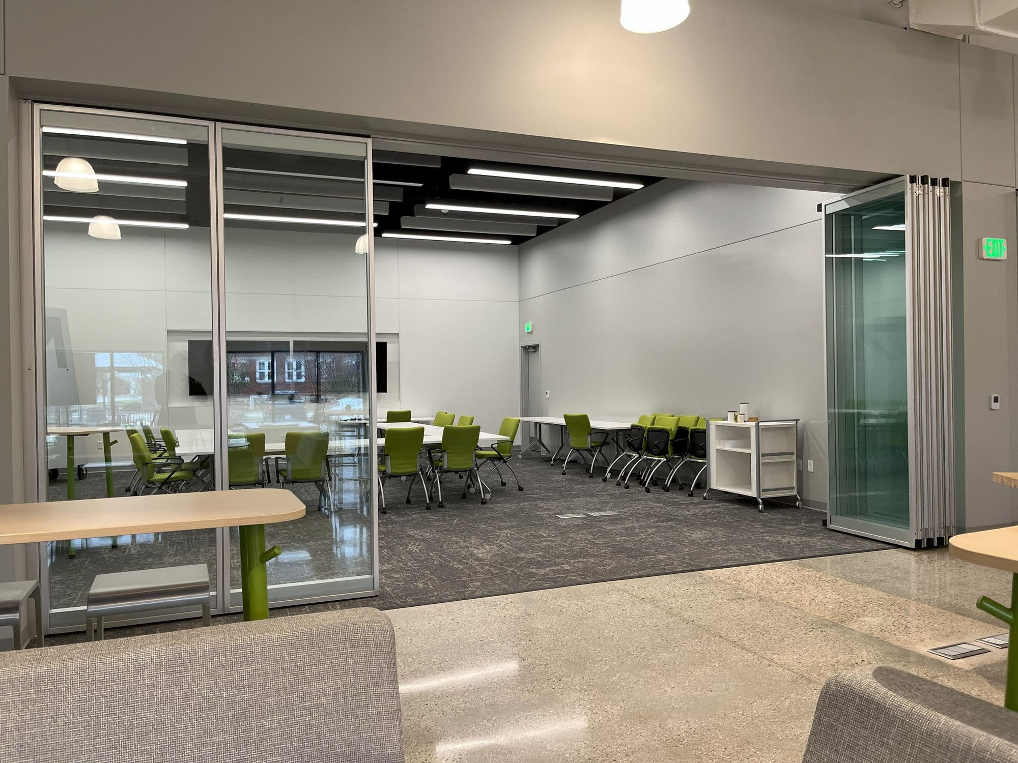 GMB Grand Rapids Learning Hub open to the office with the clear anodized framed glass panels stacked at the side