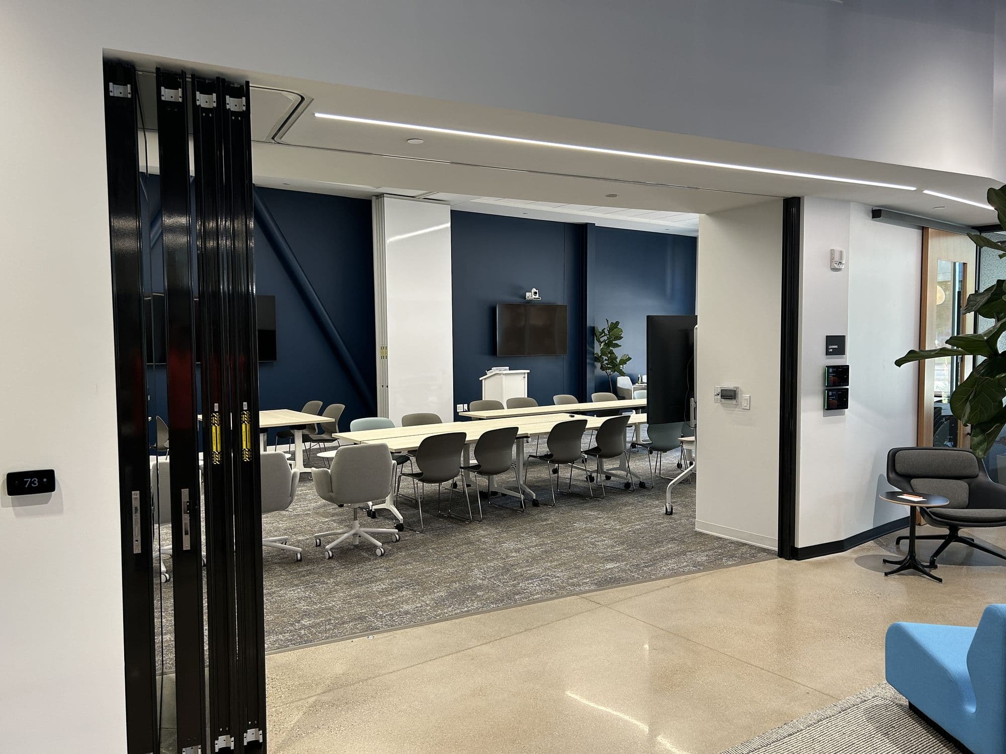 Open conference room at Lakeshore Advantage with the glass panels stacked against the wall