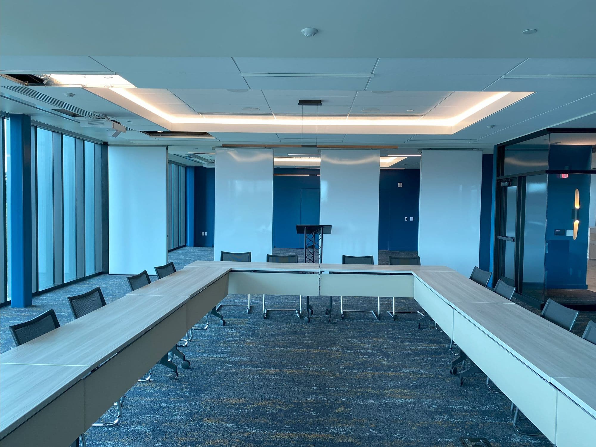 Markerboard Acousti-Seal panels spaced apart as the partition opens, seen from the boardroom table at Michigan Realtors