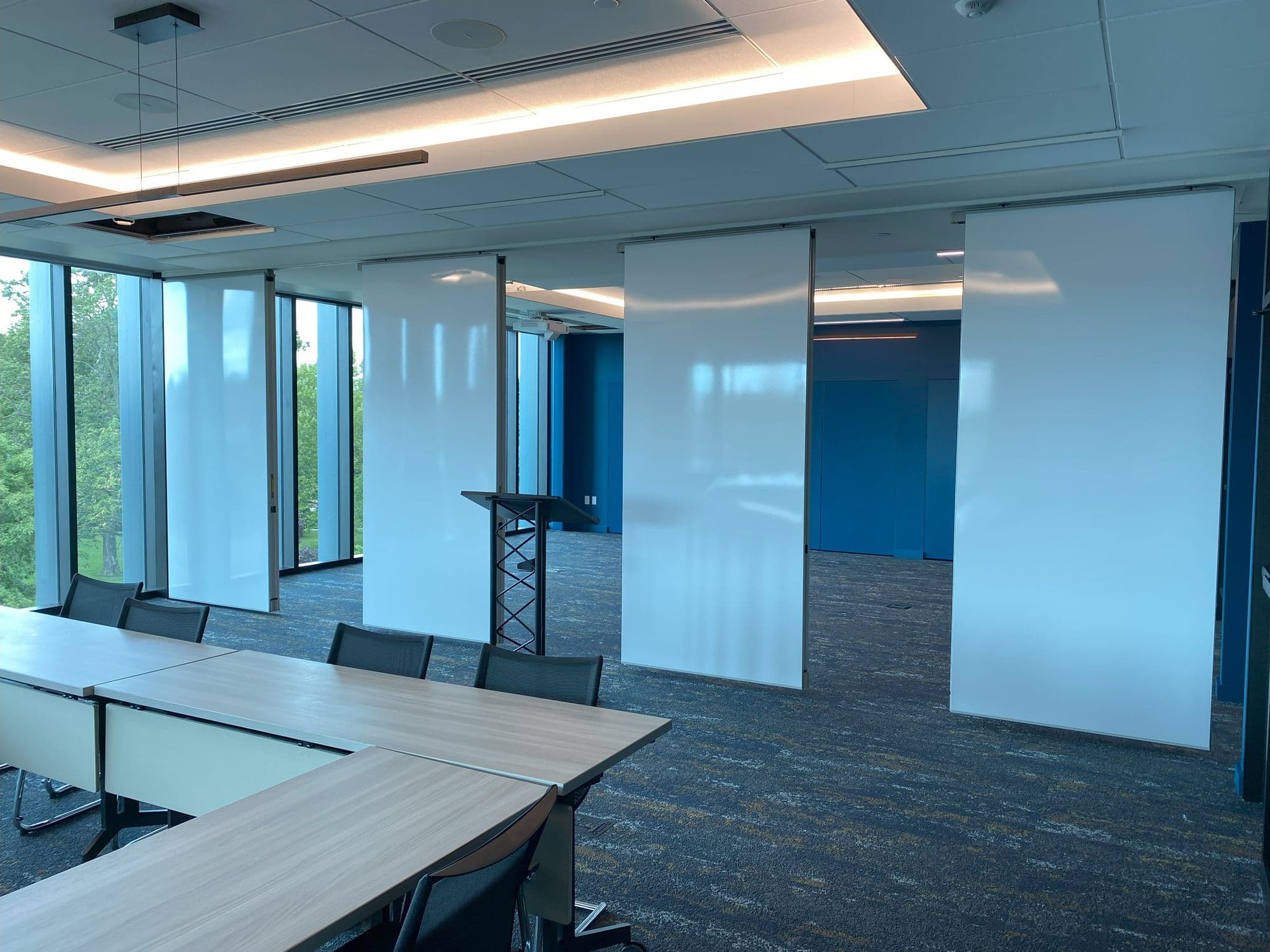 Michigan Realtors boardroom opened up, with the white markerboard panels spaced apart along the track