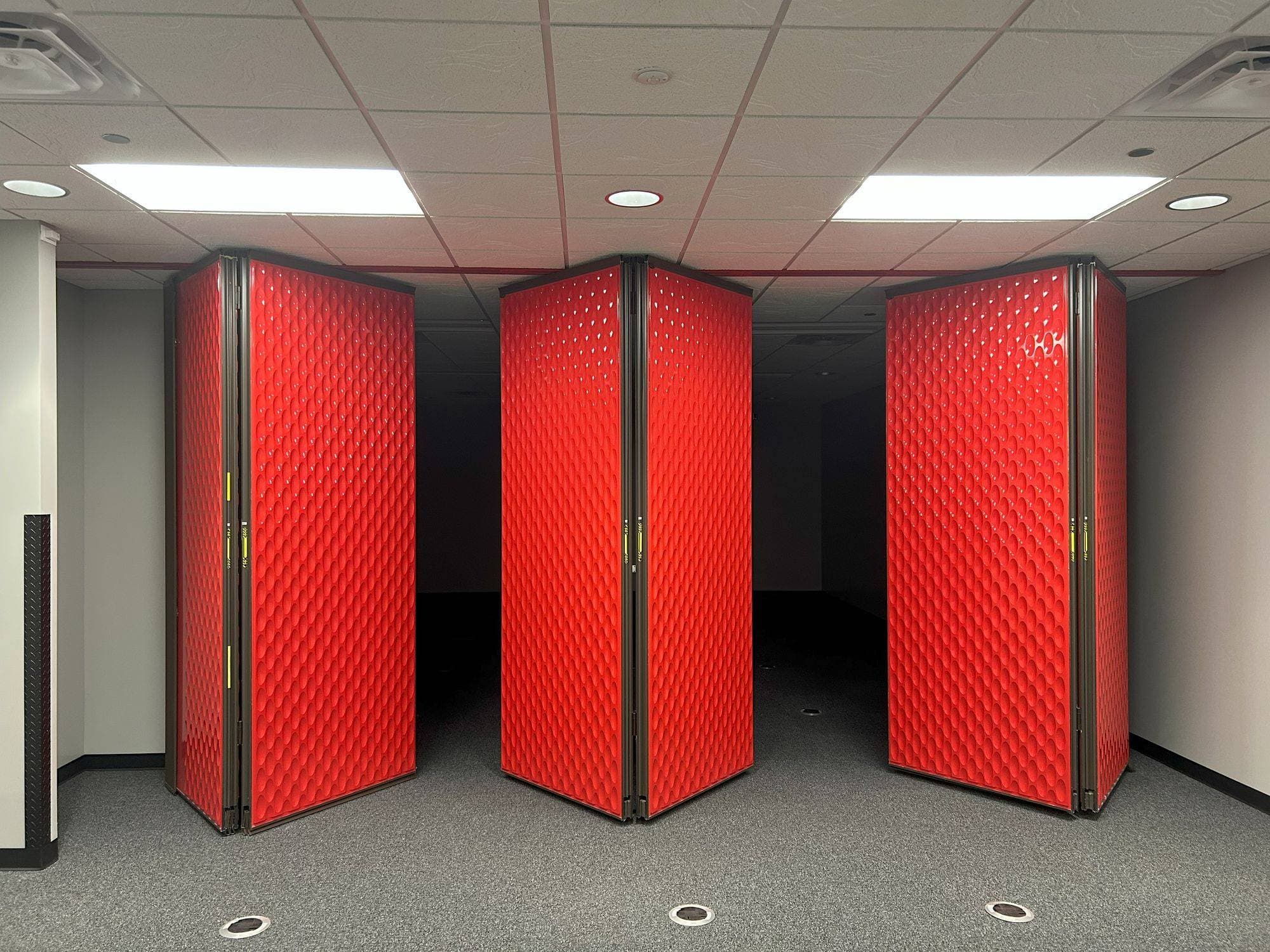 Acousti-Seal panels in red designer line finish folded in pairs along the track as the wall opens at Switch