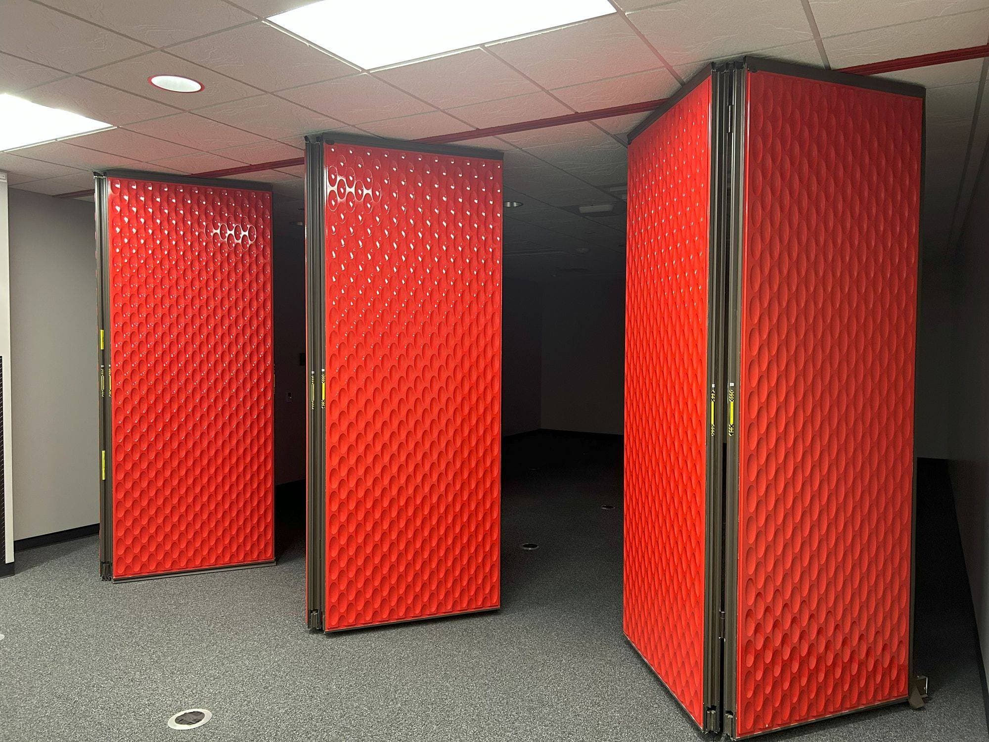 Folded pairs of red designer line folding panels seen from an angle at Switch