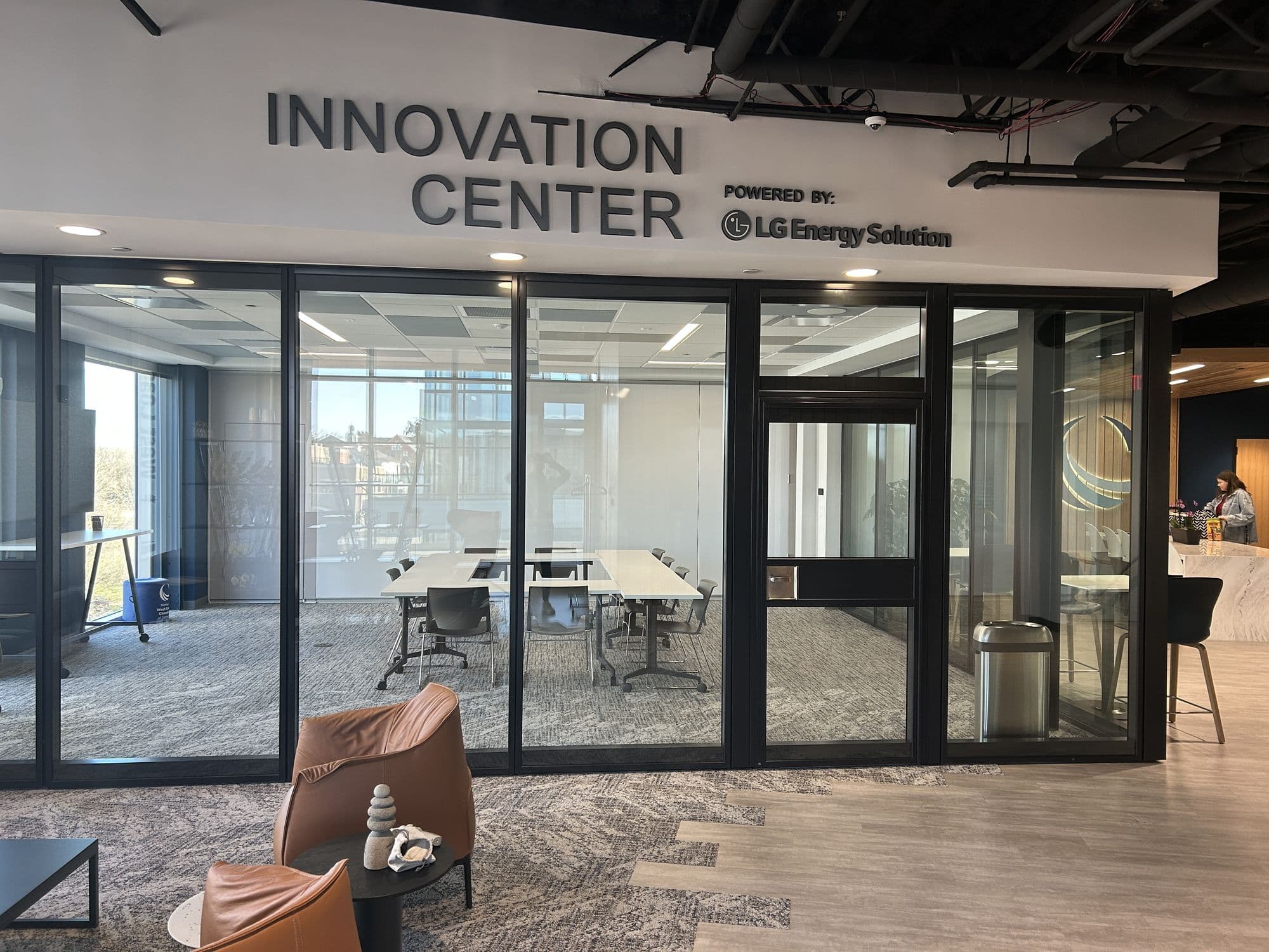 Closed Acousti-Clear glass wall below the Innovation Center sign, powered by LG Energy Solution, at the West Coast Chamber of Commerce