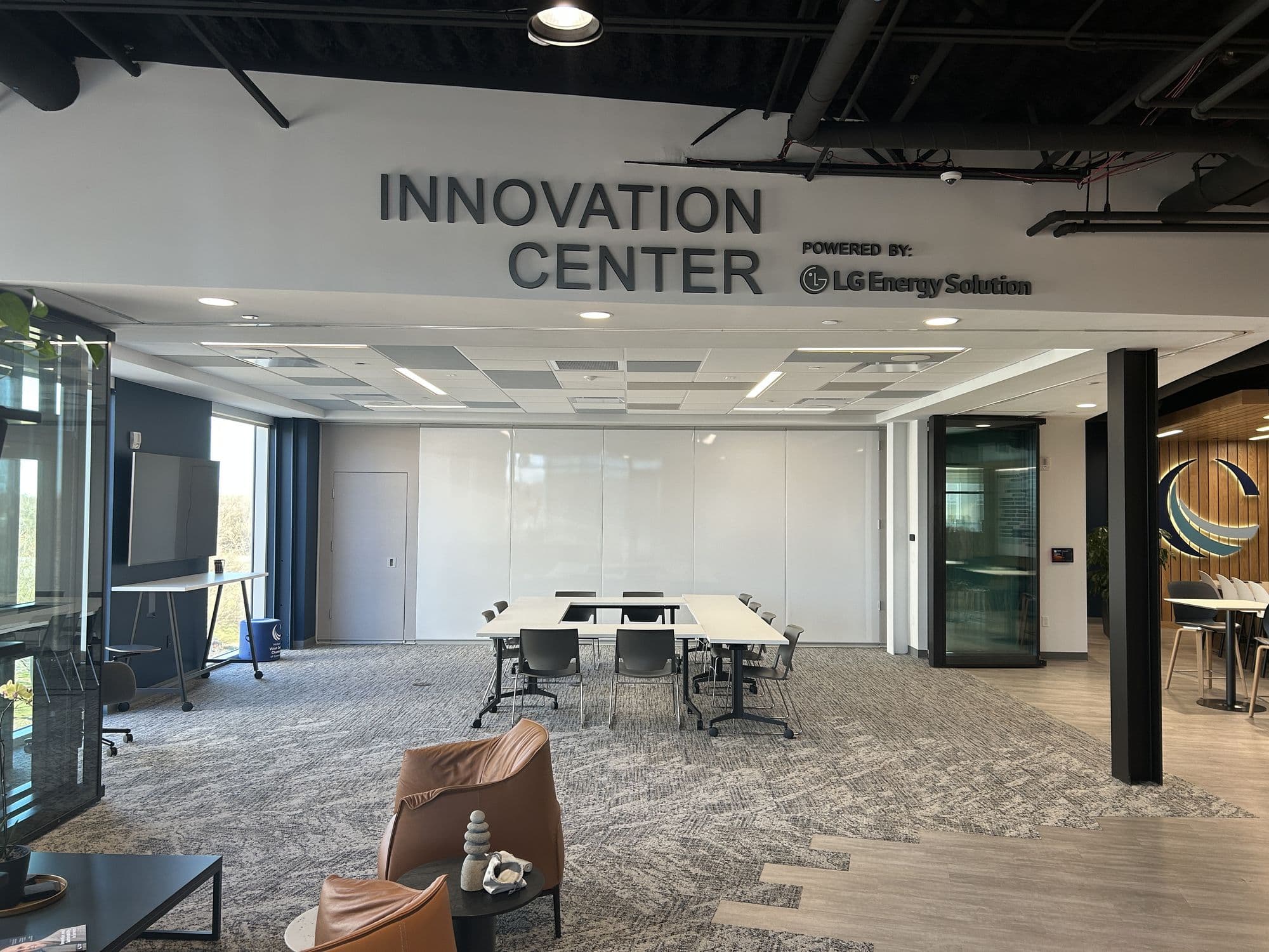Innovation Center open to the office with the glass wall stacked away, under the Innovation Center sign