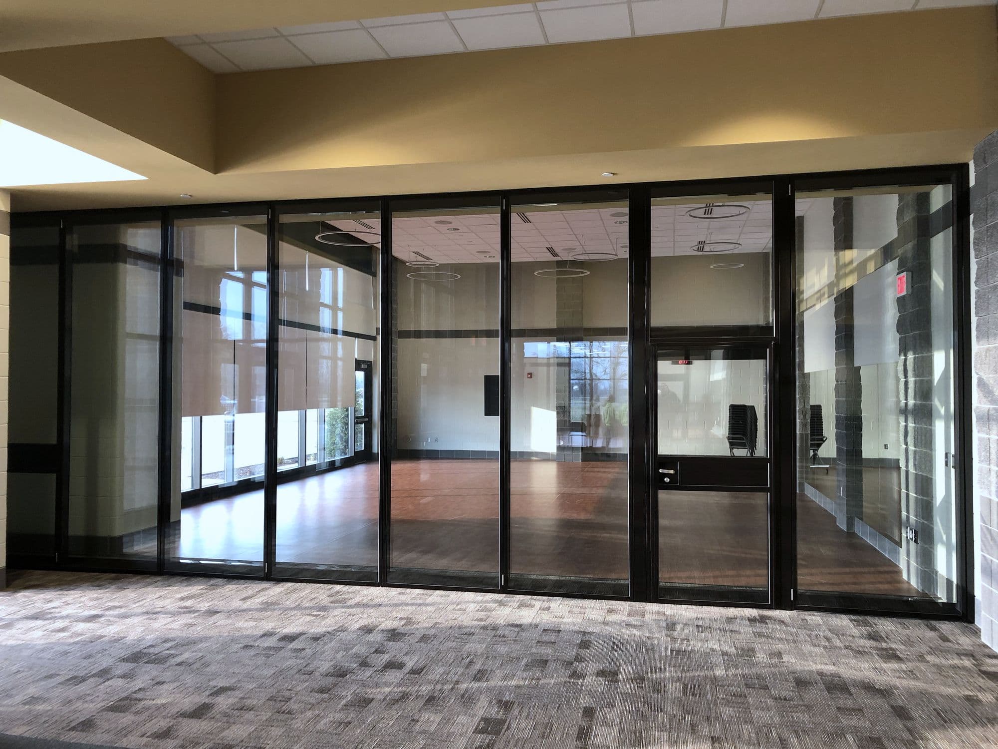 Straight-on view of the closed Acousti-Clear glass wall and pass door at Zeeland East High School