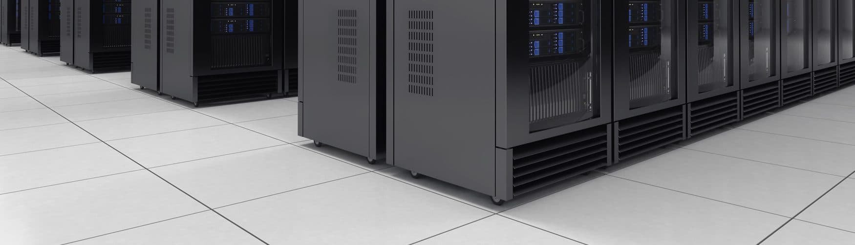 Rows of server racks standing on a white high pressure laminate raised floor in a data center