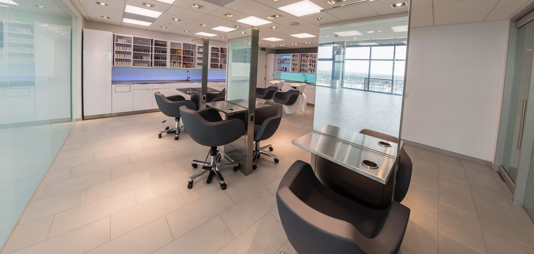 Open office meeting area with conference table and lounge chairs on a light laminate access floor