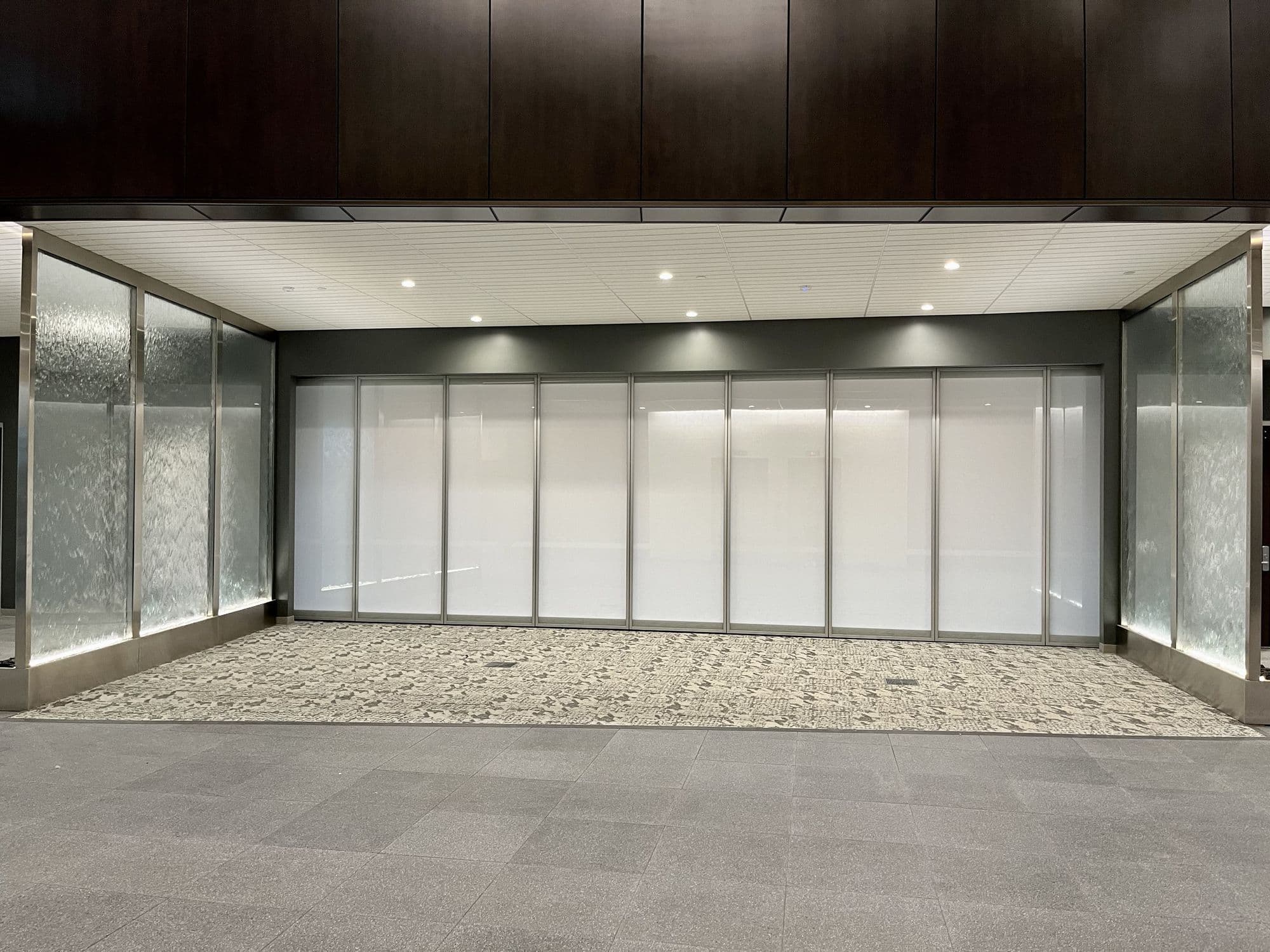 Straight-on view of the closed Modernfold Acousti-Clear wall at Advia Credit Union with frosted white MorphGlas panels