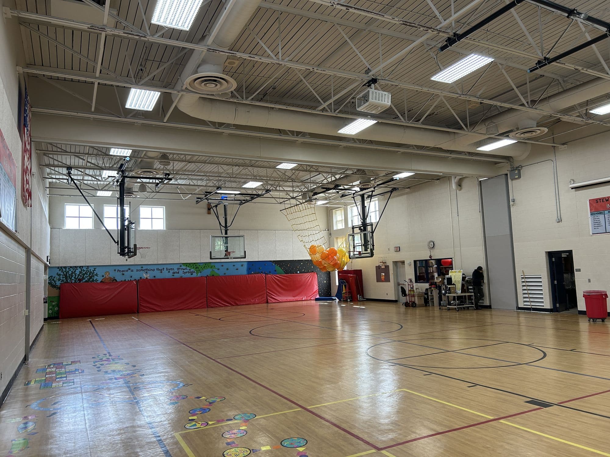 Stewart Elementary gym at Lakeshore Community Schools open to its full width, with the Modernfold Acousti-Seal Premier Electric operable wall stacked against the right side
