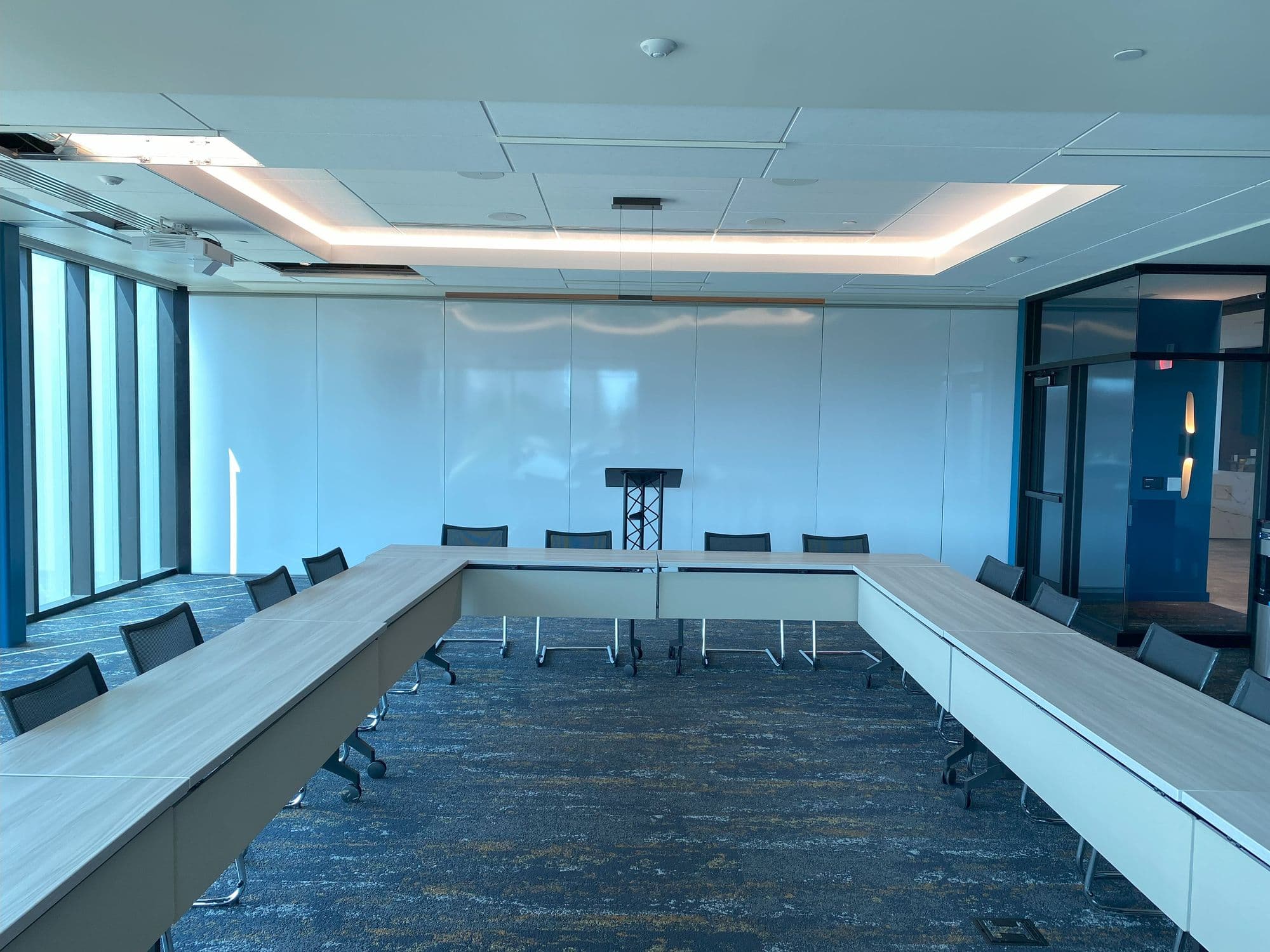 Closed Modernfold Acousti-Seal partition with a white markerboard finish at the end of a U-shaped boardroom table at Michigan Realtors