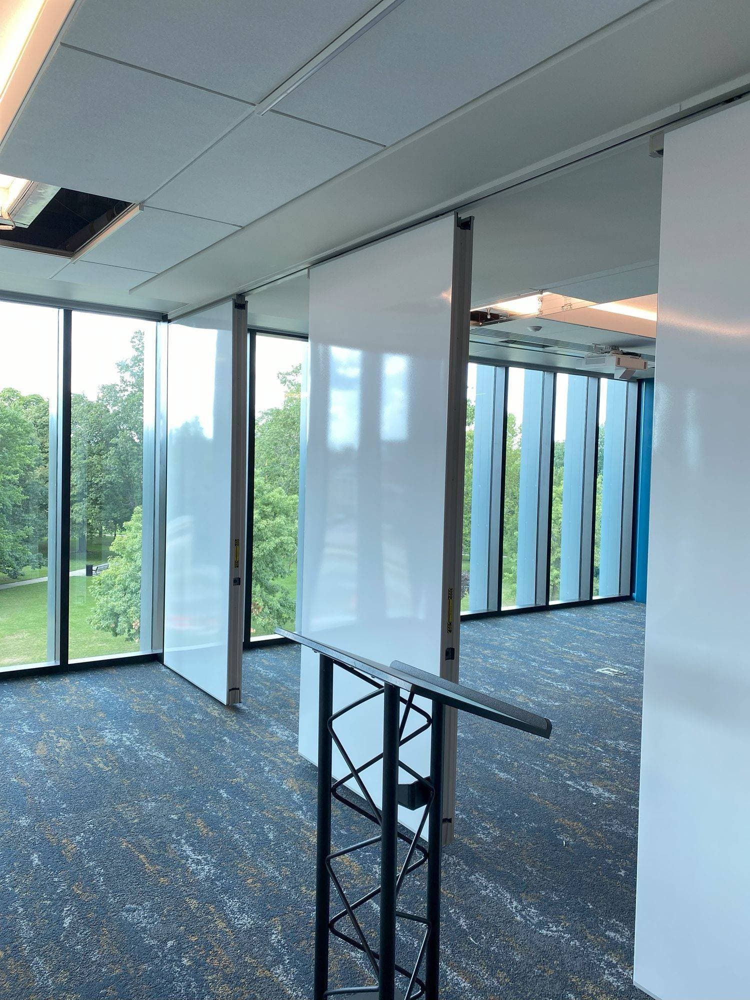 White markerboard panels spaced apart near the windows as the partition opens at Michigan Realtors
