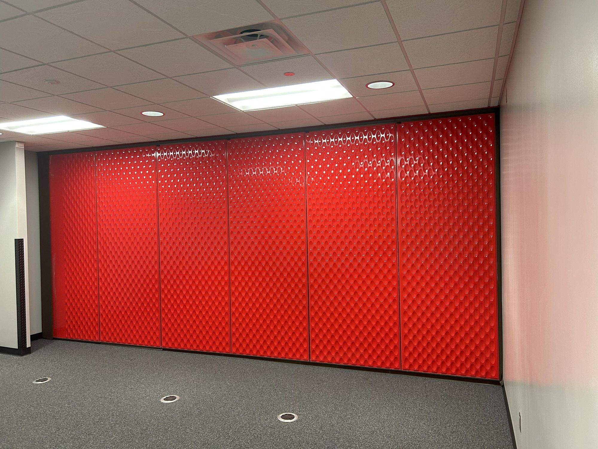 Red designer line Acousti-Seal partition closed, seen from an angle at Switch